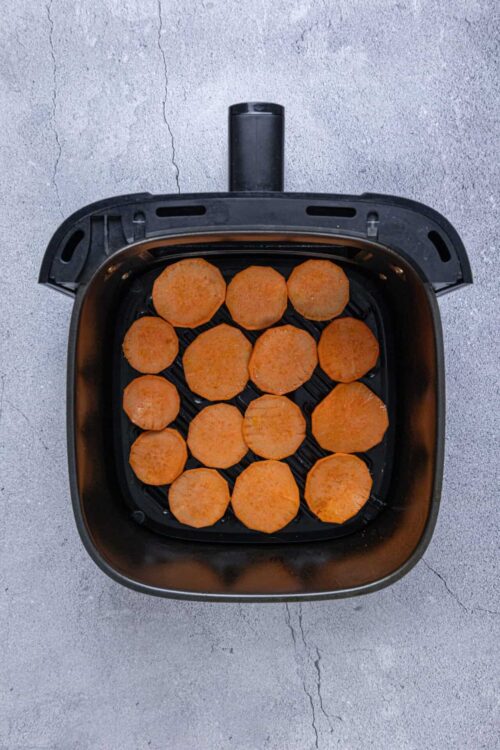 Sweet potato slices in air fryer for healthy snack or side dish.