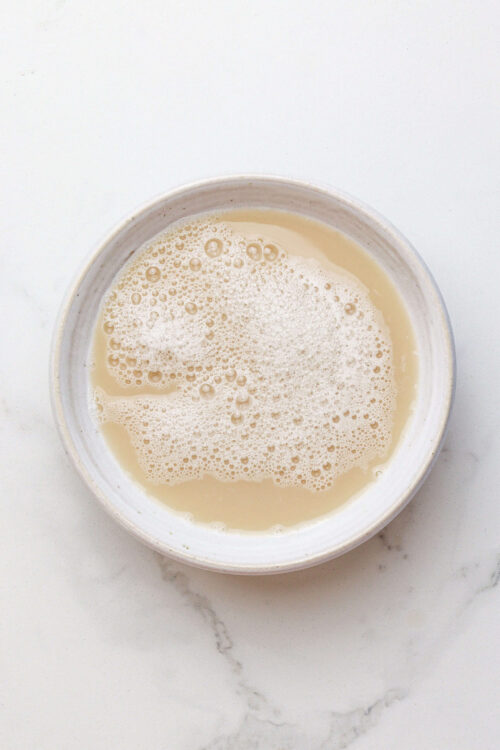 Creamy homemade custard in a white bowl, ready for baking or dessert recipes.