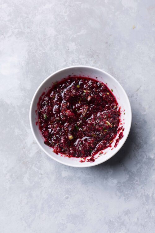 Fresh homemade berry compote in a white bowl, perfect for baking and breakfast recipes.