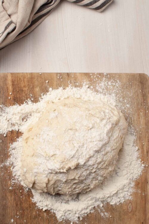 Flour and dough on wooden surface for baking bread or pastry.