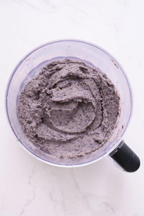 Creamy blueberry smoothie mixture in a blender.