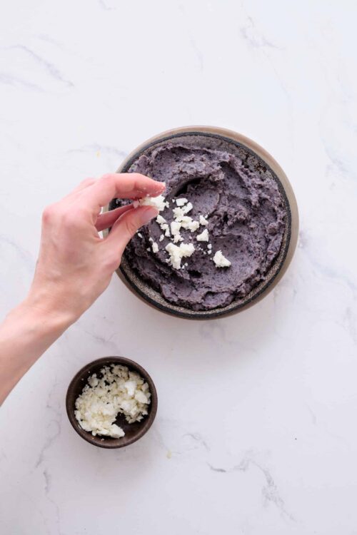 Rich purple sweet potato ice cream with white chocolate chunks in a bowl.
