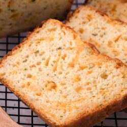 Buttery garlic bread slices fresh from the oven, crispy crust with herbs and garlic flavor.