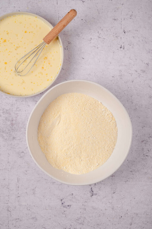 Flour and eggs in bowls for baking bread or cake preparation.