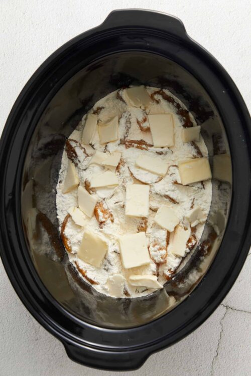 Butter and flour layered in a slow cooker for baking or cooking recipes.
