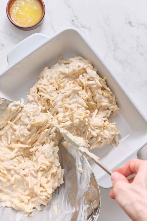 Buttermilk ranch chicken salad in a white dish with shredded chicken and creamy dressing, ready to serve.