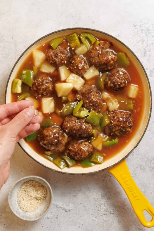 Hearty homemade meatball stew with vegetables in a cast iron skillet.