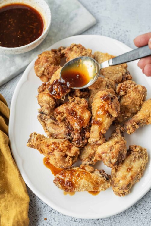 Crispy fried chicken wings with sweet and tangy sauce, perfect for appetizer or party snacks.