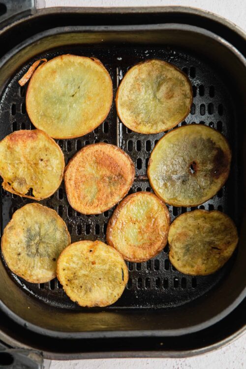 Crispy roasted potato slices in an air fryer for easy and healthy side dish.