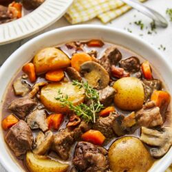 Hearty beef stew with potatoes, carrots, and mushrooms in a flavorful broth. Perfect comfort food recipe for cold days.