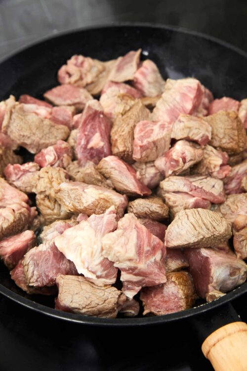 Crispy browned beef stew meat browned in a skillet.