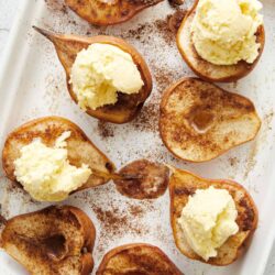 Sweet baked pears with cinnamon, served with vanilla ice cream for a comforting dessert.