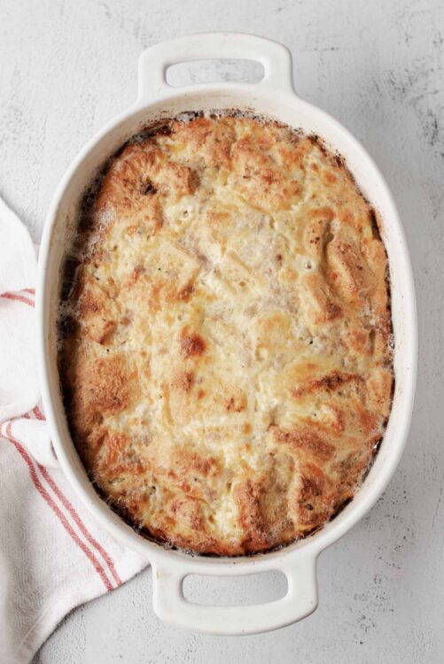 Creamy chicken and mushroom casserole with melted cheese in a white baking dish.