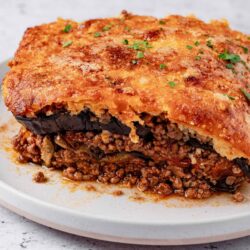 Savory ground beef and eggplant casserole on white plate, baked Bree recipe, comfort food dinner, cheesy baked eggplant casserole, easy family meal.