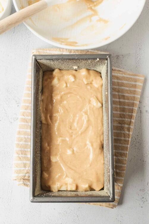 Creamy cinnamon swirl bread dough in loaf pan, ready to bake for homemade bread.