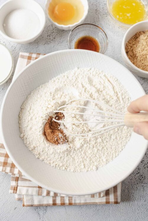 Flour, cocoa powder, and spices in a mixing bowl for baking brownies or cake.