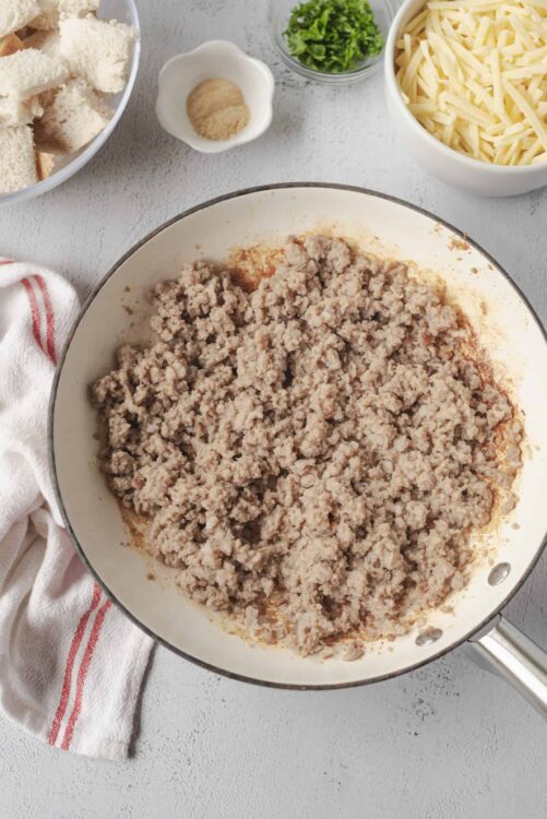 Ground turkey being browned in a skillet for a casserole dish.