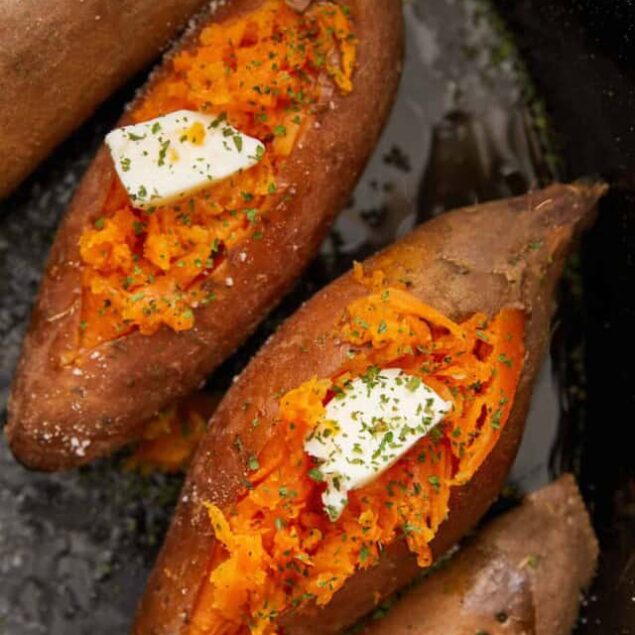 Roasted sweet potatoes stuffed with seasoned mashed sweet potatoes, topped with sour cream and herbs.