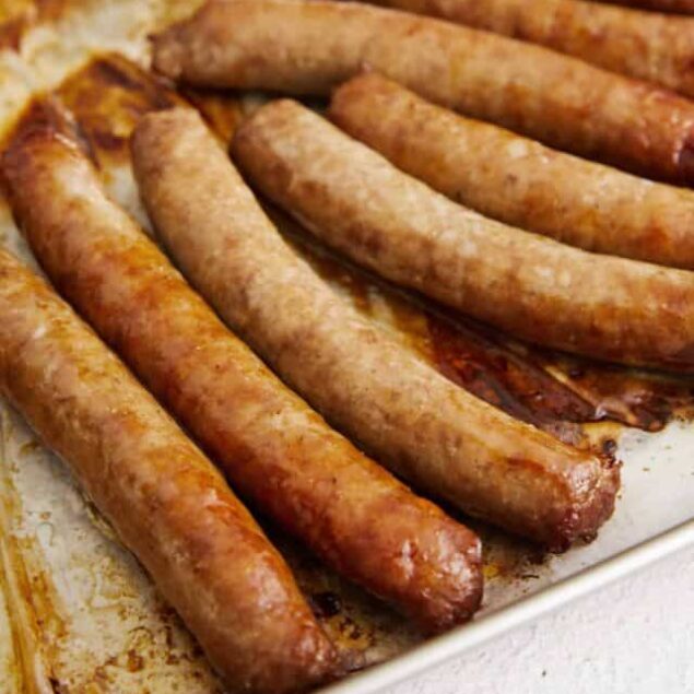 Golden cooked breakfast sausage links in a baking dish.