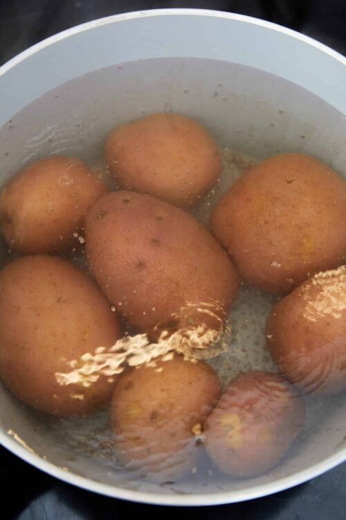 Boiling brown eggs in water for easy peeling and preparation.