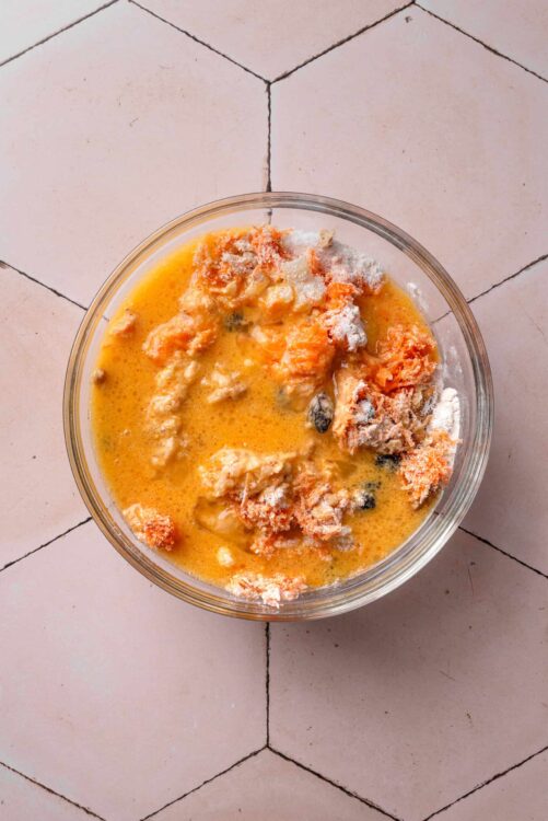 Creamy salmon and cheese mixture for baking on tiled surface, ready for oven.