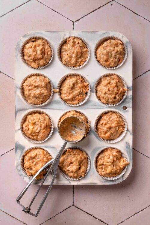 Mini carrot cake batter in cupcake liners ready to bake.
