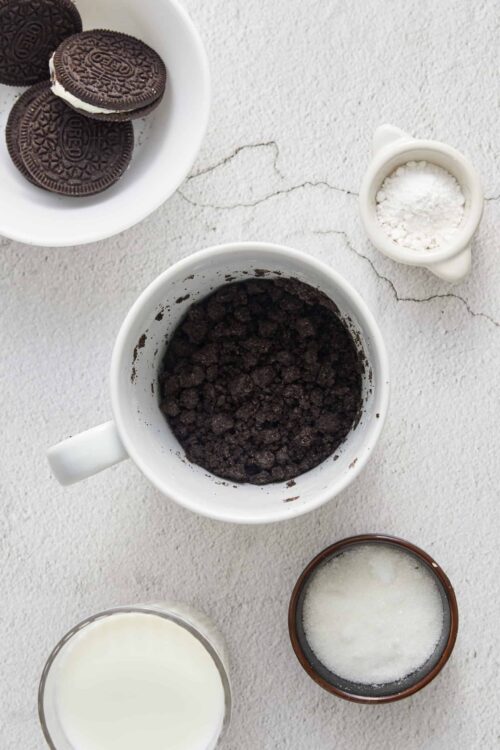 Oreos cookies, crushed cookies, milk, powdered sugar ingredients for baking or dessert recipes.