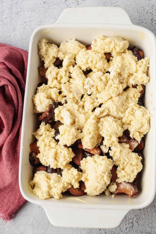 Butter tart filling with chopped cherries in baking dish.