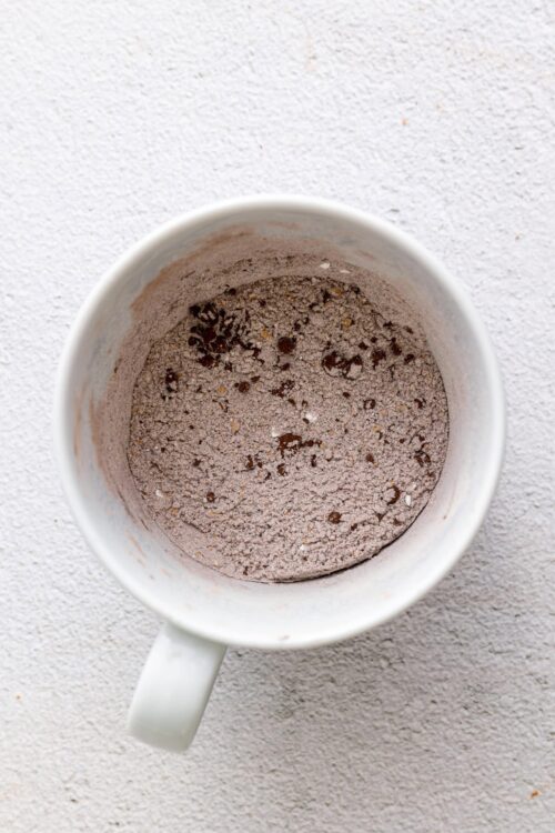Chocolate cake mix in a white mug ready for baking.
