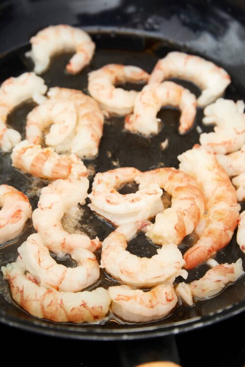 Juicy shrimp cooking in a skillet, perfect for seafood recipes and dinner ideas.