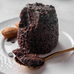 Rich chocolate lava cake with gooey center served on a white plate. Dark, decadent dessert perfect for chocolate lovers.