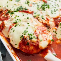 Creamy baked eggplant parmesan with melted mozzarella and fresh herbs in a rich tomato sauce.