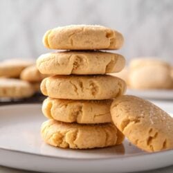 Buttery shortbread cookies stacked on a white plate, perfect for baking and holiday treats.