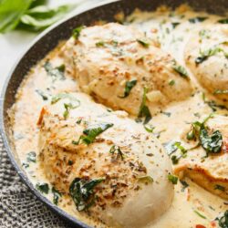 Creamy chicken skillet with herbs and spices in a flavorful sauce. Perfect for a comforting dinner with fresh herbs.