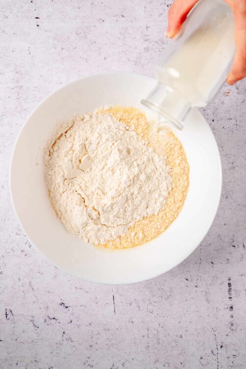 Flour and milk in a mixing bowl for baking.