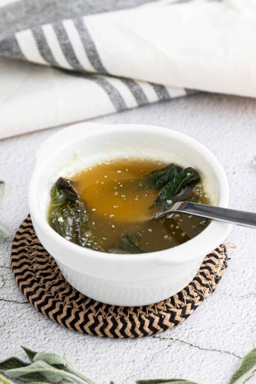 Comforting homemade chicken and wild rice soup with herbs in a white bowl.
