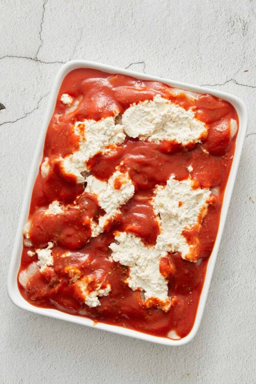 Creamy chicken parmesan casserole with marinara sauce and melted cheese. Perfect comfort food recipe for dinner or meal prep.