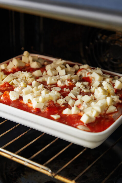 Cheese and tomato casserole baking in the oven.