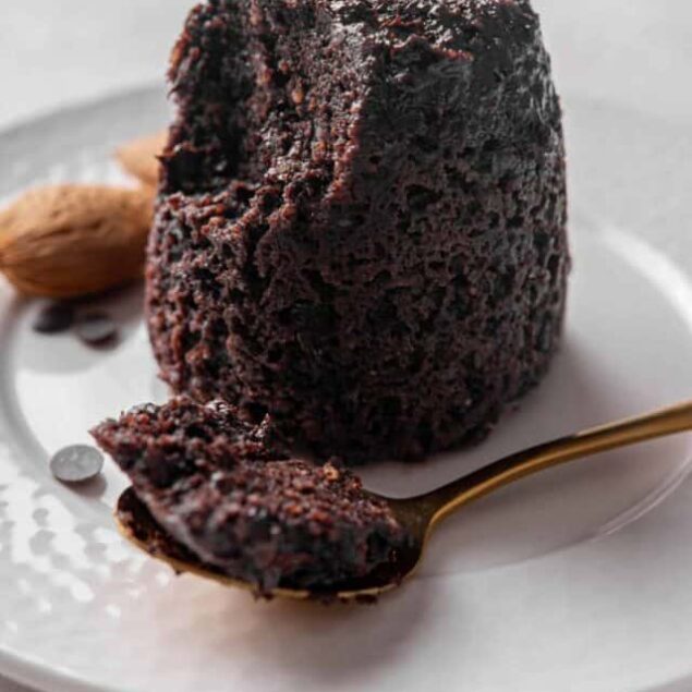 Rich chocolate lava cake with gooey center served on a white plate. Dark, decadent dessert perfect for chocolate lovers.