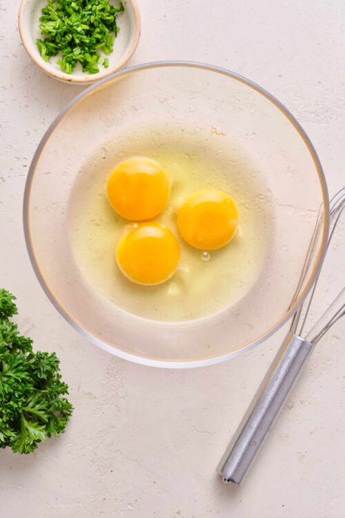 Whisked eggs in a glass bowl for baking or cooking recipes.
