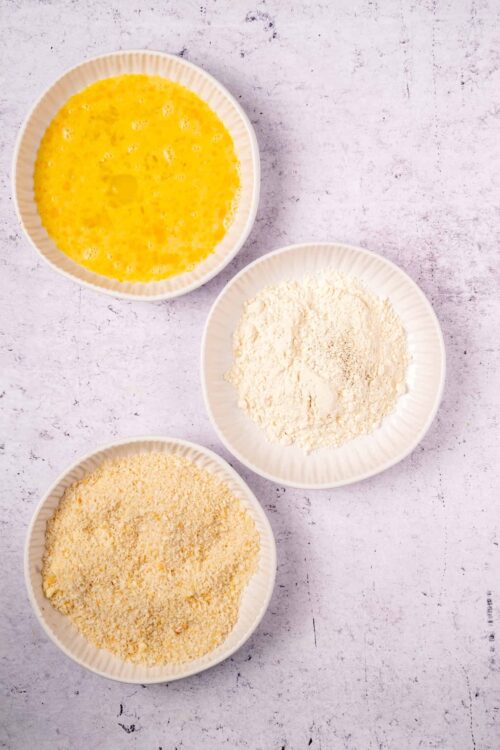 Flour, eggs, and bread crumbs for baking or cooking preparations.