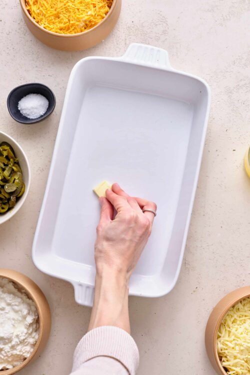 Softened butter on baking dish for casserole preparation.