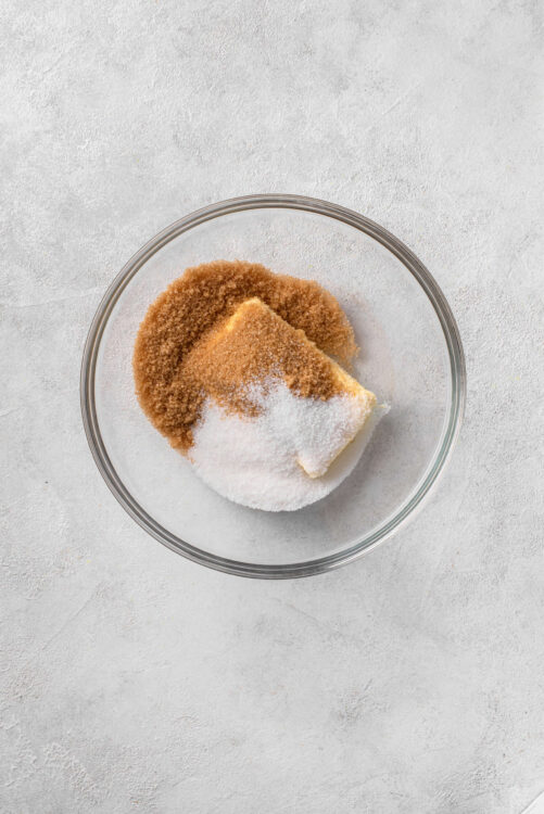 Sweetened condensed milk and brown sugar in a glass bowl for baking recipes.