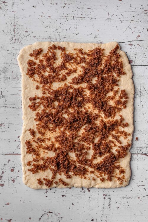 Butter pastry dough with cinnamon sugar filling for homemade cinnamon roll casserole.