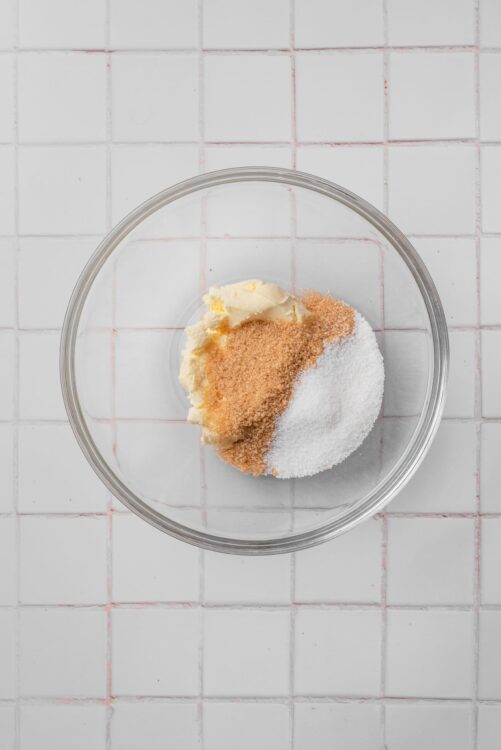 Cream cheese, butter, sugar, and vanilla extract in a glass bowl, ready for baking.