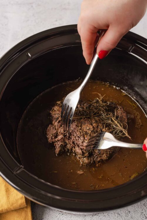 Slow cooker pot roast with herbs and broth.