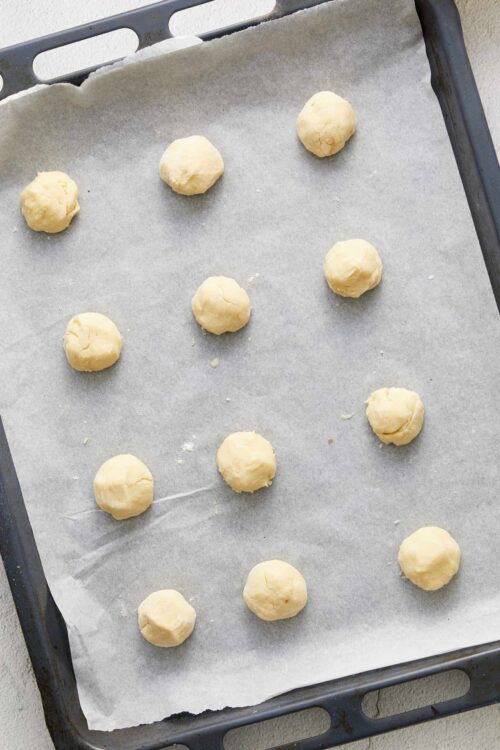 Dough balls on baking sheet for cookies, ready to bake.