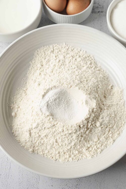 Flour in a white mixing bowl for baking recipes.