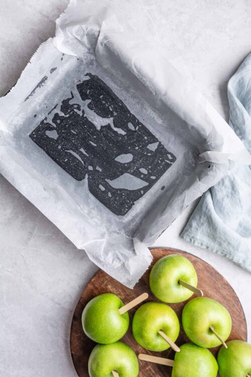 Baked Bree black and white drawing on parchment paper with green apples on wooden board for healthy baking.