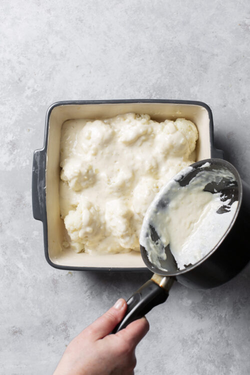 Creamy cauliflower cheese, baked until golden and tender, with rich cheese sauce in a baking dish.